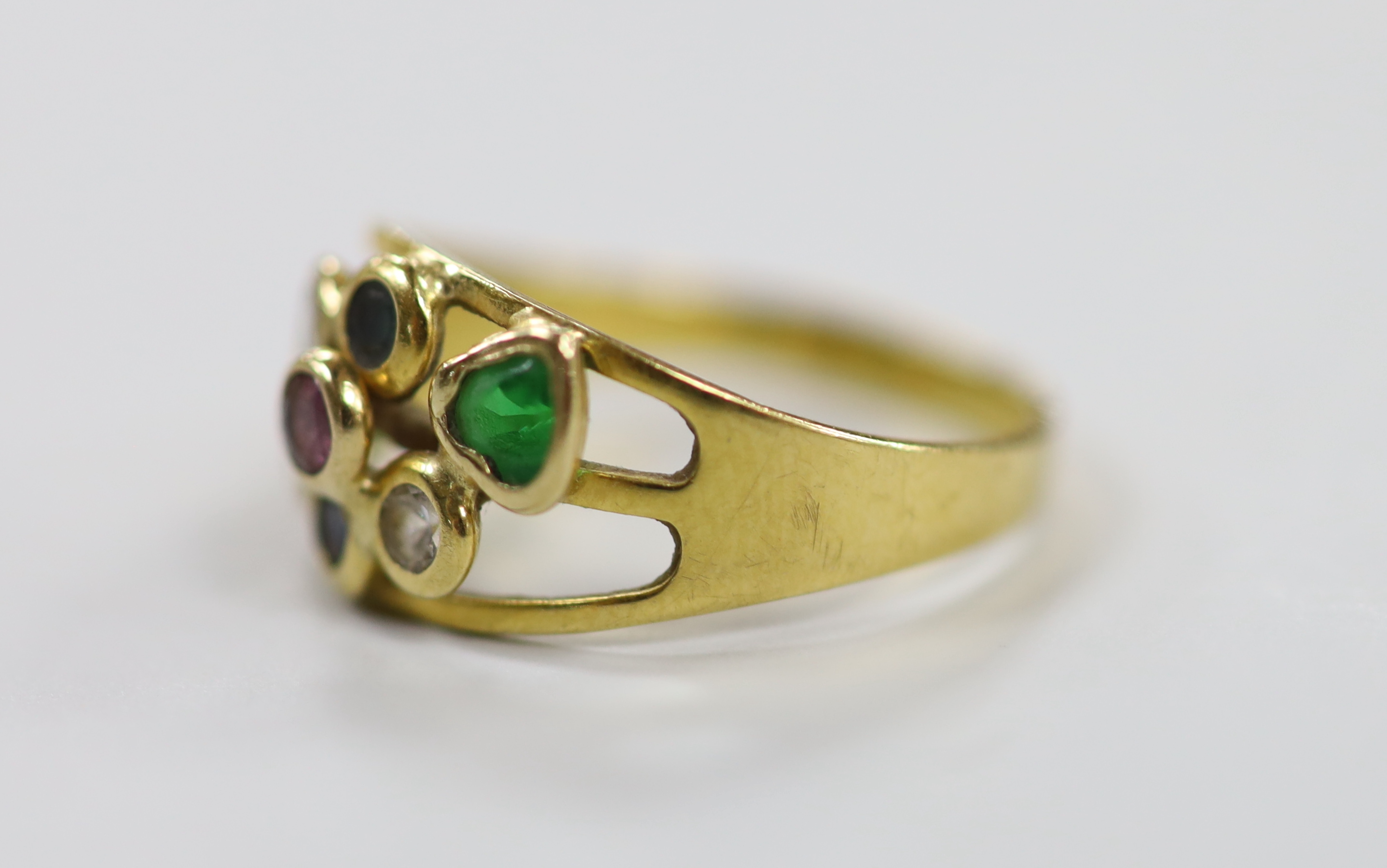 A modern Italian 750 yellow metal and seven stone multi gem collet set ring, size O, gross weight 2.8 grams.